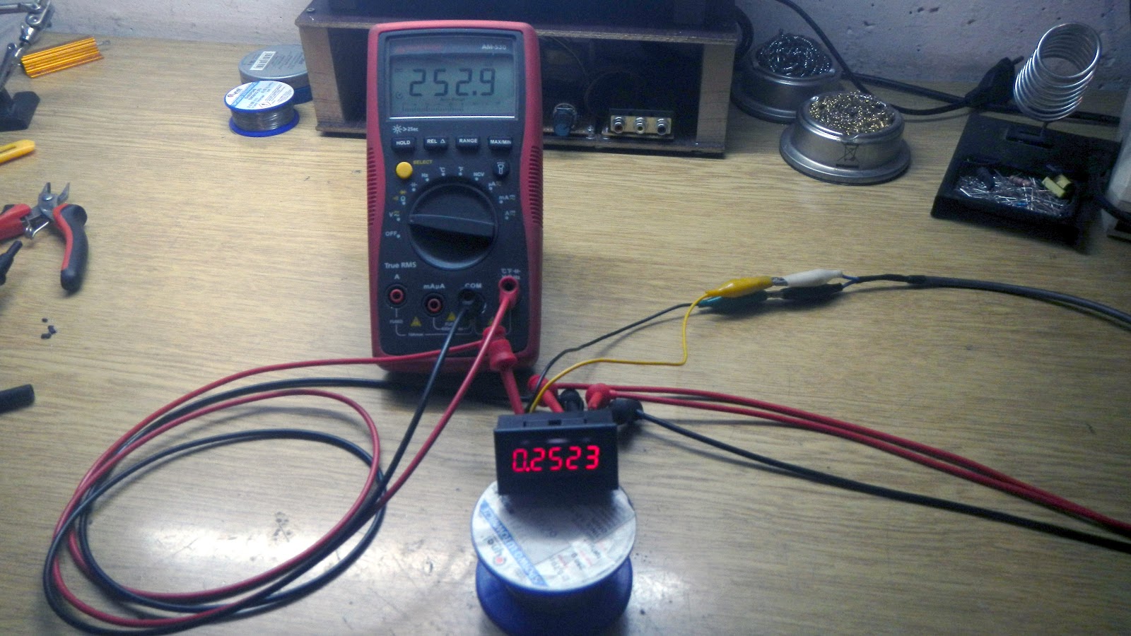 Panel voltmeter with the peak voltage detector, next to a multimeter