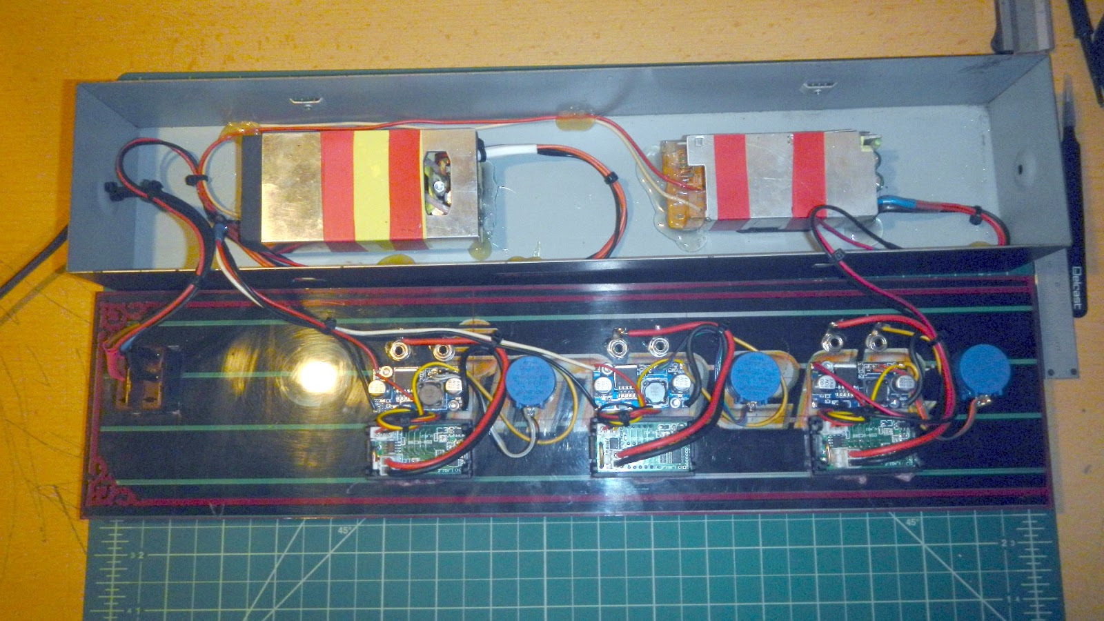 Inside the power supply: two adapters in the case and three DC-DC modules behind the front panel